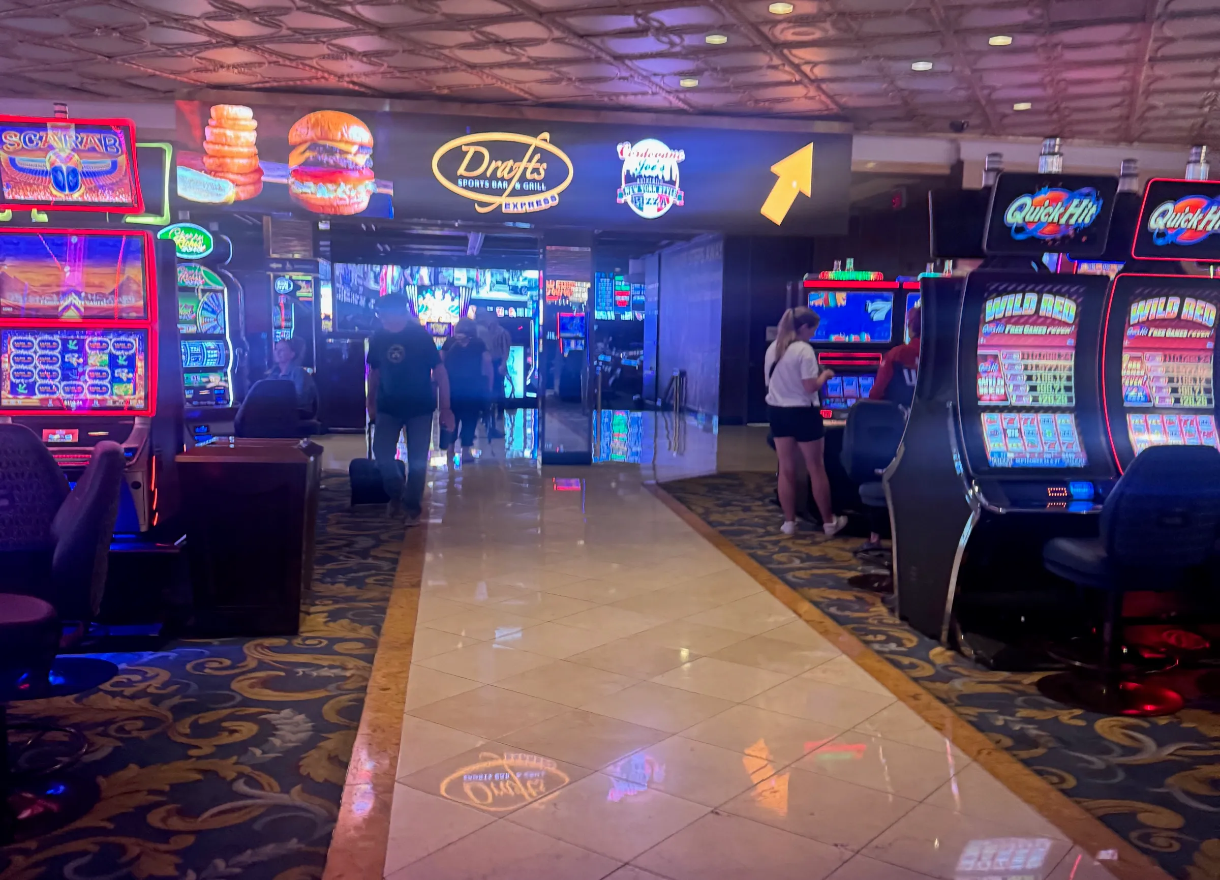 The casino floor at the Westgate, slot machines and patterned carpet, on the walk toward the sportsbook